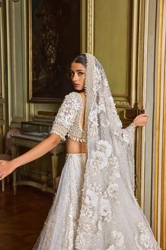 a woman in a wedding dress with a veil on her head