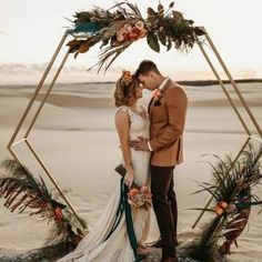 a newly married couple standing in the desert