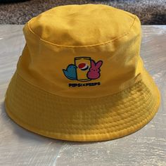 Never Worn! Cute Pepsi X Peep Embroidery. Unisex. Yellow Summer Cotton Bucket Hat, Yellow Cotton Summer Bucket Hat, Trendy Yellow Sun Hat For Vacation, Casual Yellow Cotton Bucket Hat, Retro Yellow Bucket Hat For Spring, Yellow Adjustable Cotton Bucket Hat, Trendy Yellow Bucket Hat For Beach, Trendy Yellow Beach Bucket Hat, Trendy Yellow Sun Hat For Spring