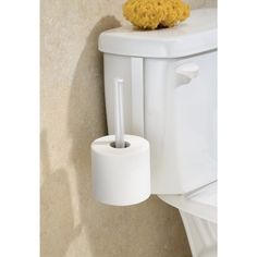 a white toilet with a roll of toilet paper on the wall next to it and a yellow sponge