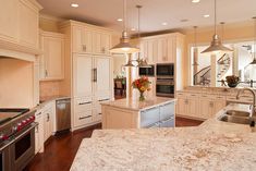 a large kitchen with an island, stove and sink in it's center area