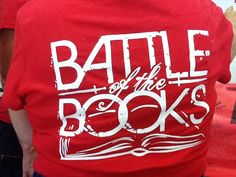 the back of a man wearing a red shirt with battle of the books printed on it