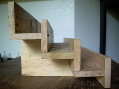 a wooden chair sitting on top of a wooden table