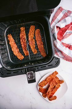 chicken strips are being cooked on the grill