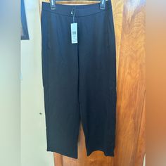 Eileen Fisher Black Pull On Pants Black Relaxed Fit Wide Leg Capris, Black Wide Leg Relaxed Fit Capris, Black Relaxed Fit Ankle-length Capris, Black Straight Leg Capris With Pockets, Casual Black Straight Leg Capris, Straight Leg Capris With Elastic Waistband For Work, Stretch Wide Leg Capris For Work, Black Ankle-length Capris With Elastic Waistband, Chic Wide-leg Workwear Capris