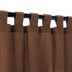 a brown curtain with black metal rod ends