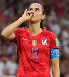 a female soccer player with her finger in her mouth