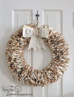 an image of a wreath made out of books on the front door with a bow