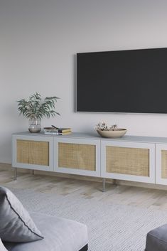 a living room with a large flat screen tv on the wall