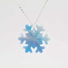 "These blue and white marbled snowflake necklaces are perfect for a Woman's Secret Santa Gift, or as a Stocking filler for her. They are handmade using polymer clay. I mixed up lots of different blue, translucent and pearly shades to give them an icy look. I also used a small amount of white glitter. Each snowflake necklace is unique and one of a kind, just like a real snowflake. I use high quality Sterling Silver jump rings and chain. The necklace chain is a beautiful 1mm diamond cut curb chain Blue Snowflake Sterling Silver Necklace, Blue Christmas Jewelry For The Holidays, Blue Christmas Jewelry For The Holiday, Blue Jewelry Christmas Gift, Blue Jewelry For Christmas Gift, Handmade White Snowflake Jewelry, Snowflake Necklace For Winter Holiday, Winter Pendant Necklace As Gift, Winter White Sterling Silver Necklaces