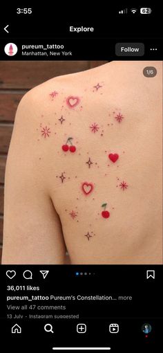 the back of a woman's shoulder with small tattoos on her left arm and chest