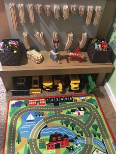 a child's play area with toys and rugs on the floor in front of it