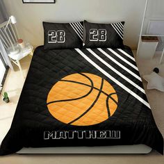 a bed with a basketball on it and two pillows in the middle that says,'23