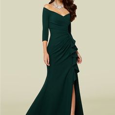 a woman in a long green dress with a slited skirt and one side split