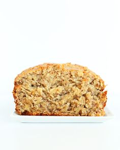 a loaf of banana bread sitting on top of a white plate