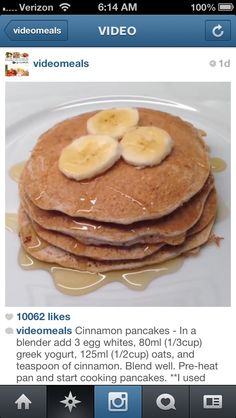 a stack of pancakes with bananas on top and syrup drizzled over them