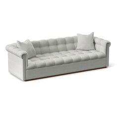 an image of a couch with pillows on it's back and the seat upholstered