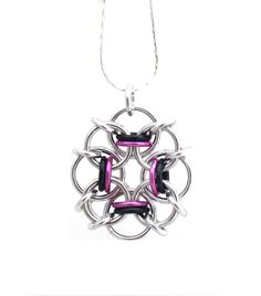 If you love the combination of black and pink, then this pendant is for you! This handmade chain maille pendant is a light and delicate way to wear a little pop of color.  This small multicolor necklace is made out of anodized aluminum jump rings in bright pink and black jump rings, as well as bright aluminum jump rings. It measures approximately 1 1/4 inches from top to bottom (including the jump ring used as a bail), by 1 inch across.  Aluminum is a very lightweight material, and the coloring Black Stainless Steel Chainmail Jewelry, Black Metal Chainmail Necklace, Chainmaille Jewelry Patterns, Spiral Jewelry, Jump Ring Jewelry, Chainmaille Jewelry, Pink Pendant, Chain Maille Jewelry, Chain Maille