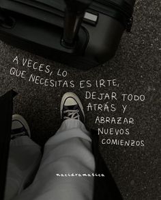 a person standing in front of a black suitcase with the words written on it and an image of their feet