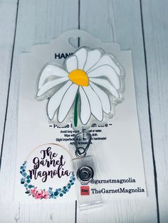 White wilted flower badge reel for any hospital worker.  Makes a great gift for medical staff, nurses (RN/LPN,ARNP), and any badge wearer, including yourself!  BASIC DESIGN-- - 2" Acrylic flower badge - Glittered by hand with adhesive vinyl placed on the blank - Epoxy resin adds protection against normal wear/tear and seals both sides - Attached to either alligator swivel clip or belt reel that clips to scrub neck, pockets, or any clothing that can hold badge.  *PLEASE NOTE: Placing multiple bad Customizable White Badge Reel For Gift, Novelty Personalized White Badge Reel, Personalized White Badge Reel As Gift, White Personalized Novelty Badge Holder, Adjustable White Badge Holder As A Gift, Customizable White Badge Reel, Nurse Hospital, Hospital Workers, Sparkle Gift