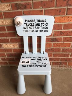 a white plastic chair with words written on it and a button that says planes trains trucks and toys for this little boy