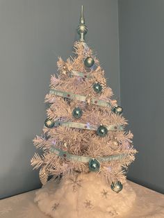 a white christmas tree sitting on top of a table