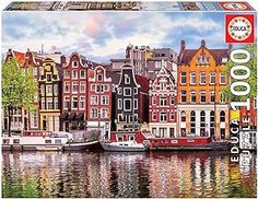 a jigsaw puzzle is shown with boats in the water and buildings on the shore