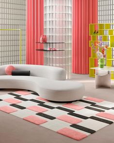 a white couch sitting on top of a rug in a living room