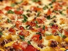 a close up of a pizza with cheese and toppings on the top, in a pan