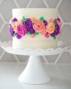 a white cake with colorful flowers on it