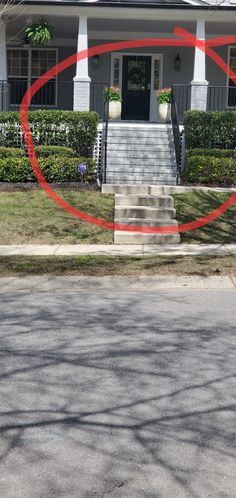 a red circle is in front of a house with steps leading up to the door