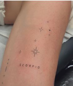 a woman's arm with the word scorpio written in cursive writing