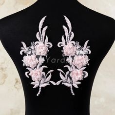 the back of a mannequin with pink flowers on it