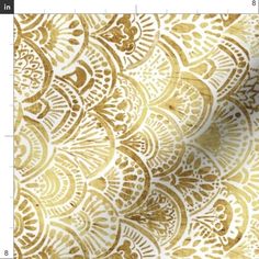 a gold and white background with an intricate design on it's side, as well as