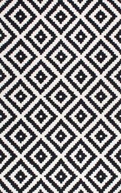 a black and white area rug with an abstract design