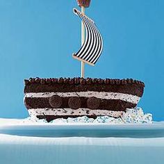 a chocolate cake with white frosting and a flag on top