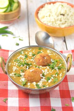 a bowl filled with soup next to another bowl full of rice and meatballs on a checkered table cloth