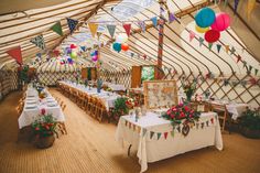 a large tent with tables and chairs in it