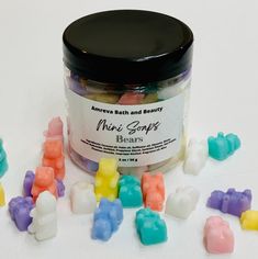 a jar filled with gummy bears sitting on top of a white table next to other gummy bears