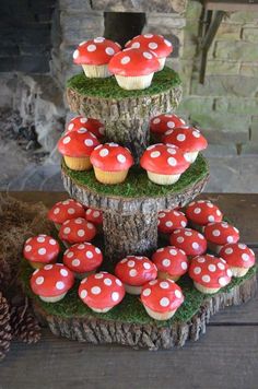 cupcakes are stacked on top of each other in the shape of trees and mushrooms