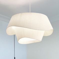 a white lamp hanging from the ceiling in a room