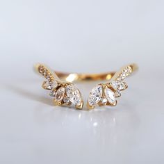 The Divine Wing ring features sparkly white marquise and round diamonds. This ring is perfect to wear alone or paired with other rings. Available in 14K yellow gold, rose gold, and white gold with CZ or natural white diamonds. This ring is designed and handcrafted in NYC. 14K solid gold band Natural marquise and round diamonds. VS-SI clarity. Approx. 0.47ct total carat weight 1.8mm ring band **This item is specially made for you. Please allow 1-2 week lead time. Shipping:Domestic: Free standard Wing Ring, Fall Rings, Solid Gold Band, Bridal Bands, Open Ring, Ring Band, Gold Band, White Diamonds, Lead Time