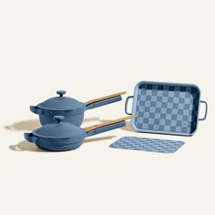 a set of blue pots and pans on a white background