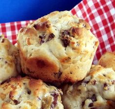 a pile of muffins sitting on top of a red and white checkered table cloth