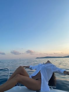 a woman laying on the back of a boat