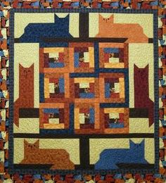 a quilted wall hanging with cats on it