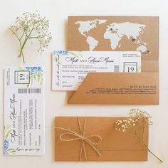 the wedding stationery is laid out on top of brown envelopes