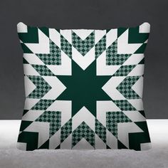 a green and white pillow sitting on top of a table