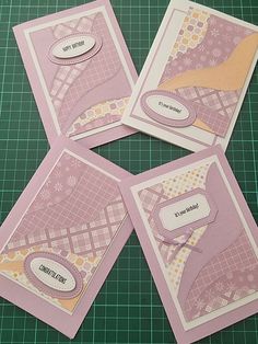 four pink cards on a green cutting board