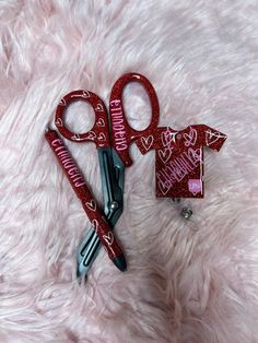 two pairs of scissors are laying next to each other on a pink furry surface with the words happy valentine's day written on it